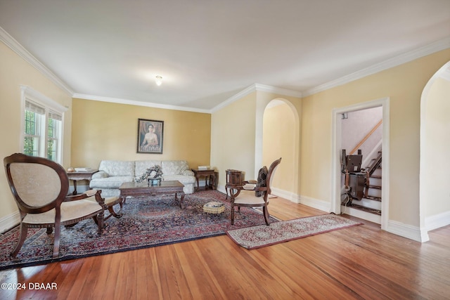 living room featuring hardwood / wood-style flooring and crown molding