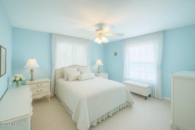 2944 Ocean Shore Blvd, Ormond Beach, FL 32176 - bedroom featuring multiple windows, light carpet, and a ceiling fan