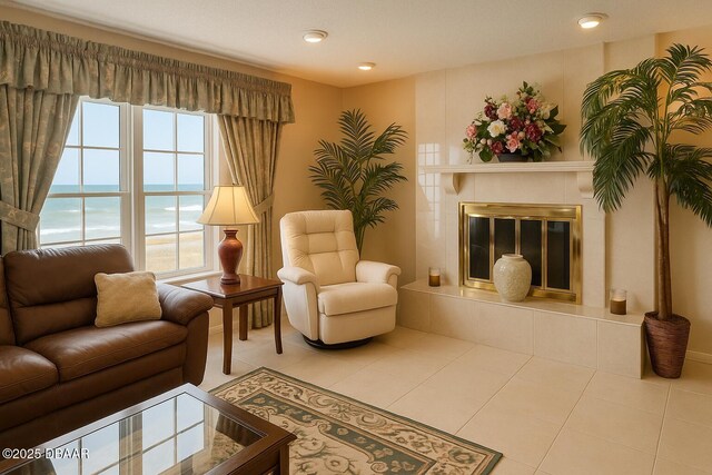 2944 Ocean Shore Blvd, Ormond Beach, FL 32176 - living area featuring tile patterned flooring, a tile fireplace, a water view, and recessed lighting