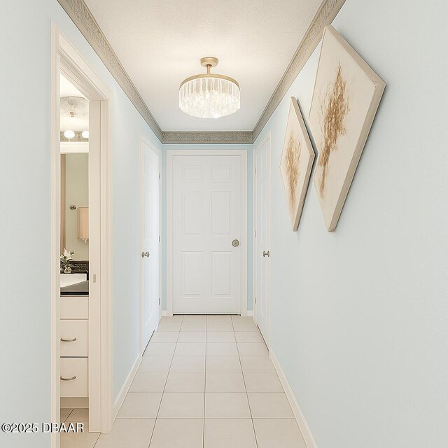 2944 Ocean Shore Blvd, Ormond Beach, FL 32176 - hallway with a chandelier, light tile patterned flooring, and baseboards