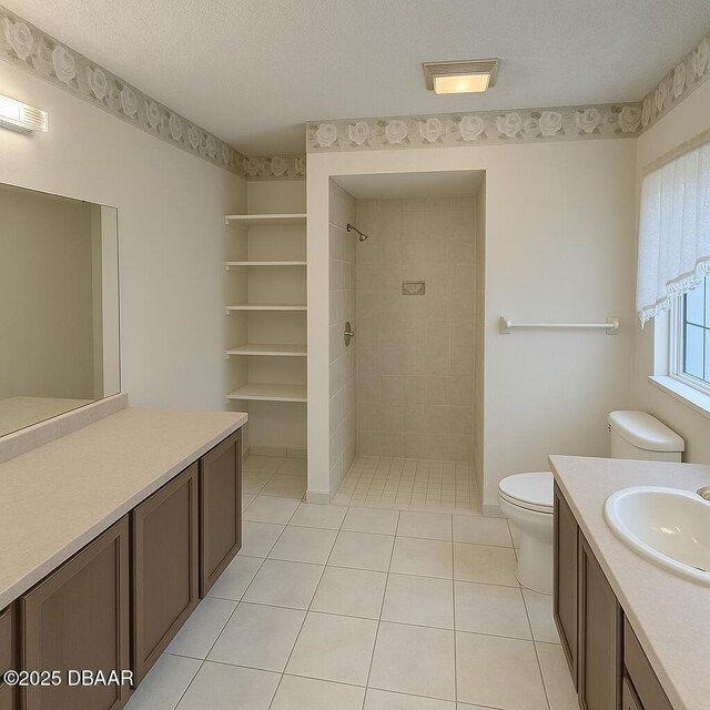 2944 Ocean Shore Blvd, Ormond Beach, FL 32176 - full bath featuring toilet, vanity, a tile shower, tile patterned floors, and a textured ceiling