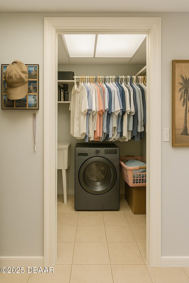 2944 Ocean Shore Blvd, Ormond Beach, FL 32176 - laundry room with washer / clothes dryer, tile patterned floors, and baseboards