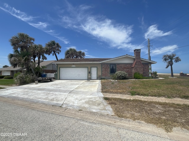 2944 Ocean Shore Blvd, Ormond Beach, FL 32176 - single story home with an attached garage, concrete driveway, a chimney, and brick siding