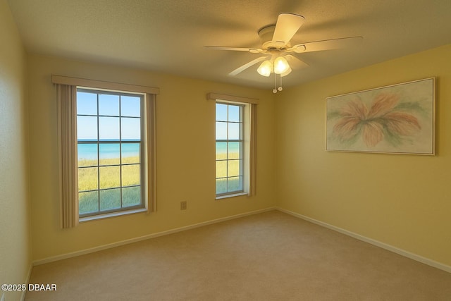 2944 Ocean Shore Blvd, Ormond Beach, FL 32176 - carpeted spare room with baseboards and a ceiling fan
