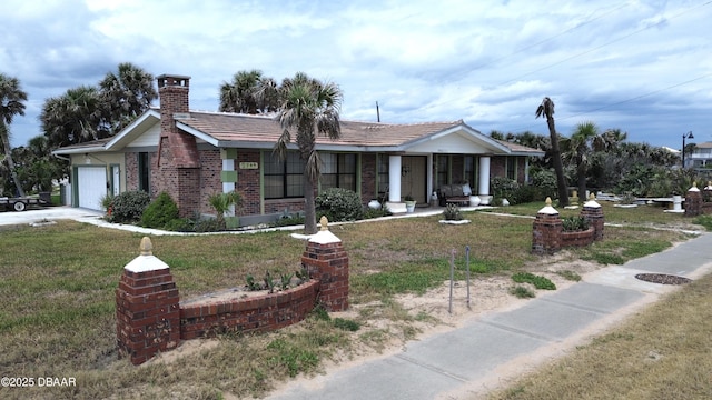 2944 Ocean Shore Blvd, Ormond Beach, FL 32176 - ranch-style home featuring an attached garage, a front yard, brick siding, a porch, and a chimney