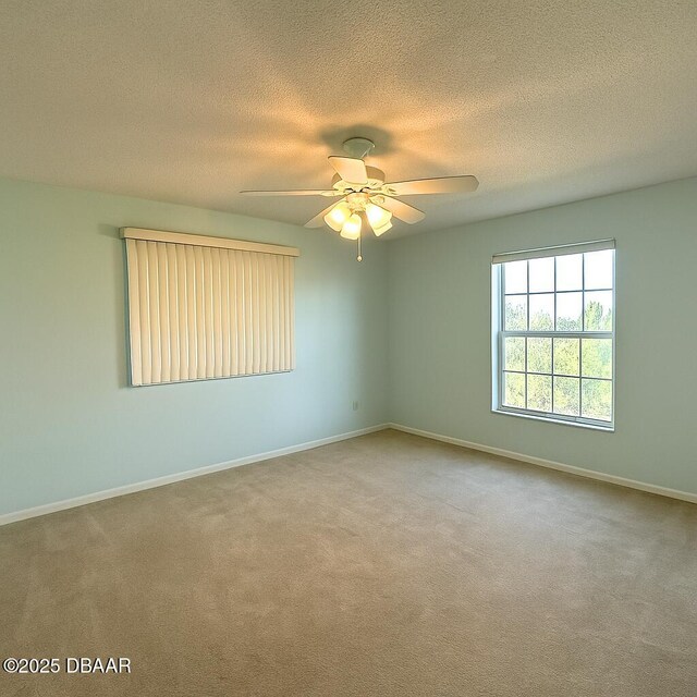 2944 Ocean Shore Blvd, Ormond Beach, FL 32176 - carpeted empty room with a ceiling fan, a textured ceiling, and baseboards