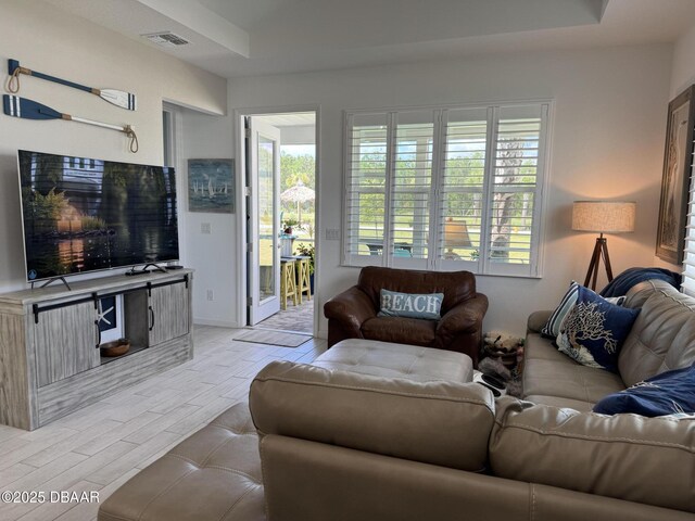 168 Ocean Hammock Loop, Daytona Beach, FL 32124 - living room featuring wood tiled floors, plenty of natural light, and a tray ceiling