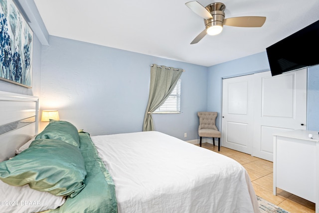 tiled bedroom with a closet and ceiling fan