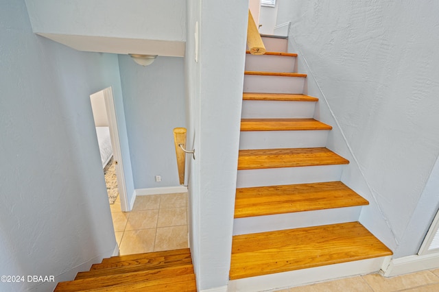 stairway with tile patterned flooring