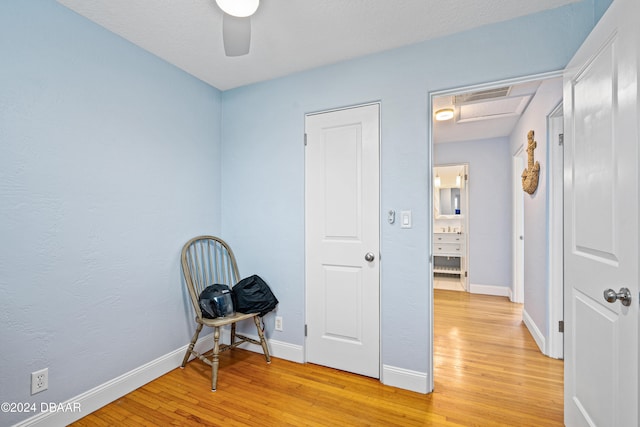 sitting room featuring ceiling fan and light hardwood / wood-style flooring