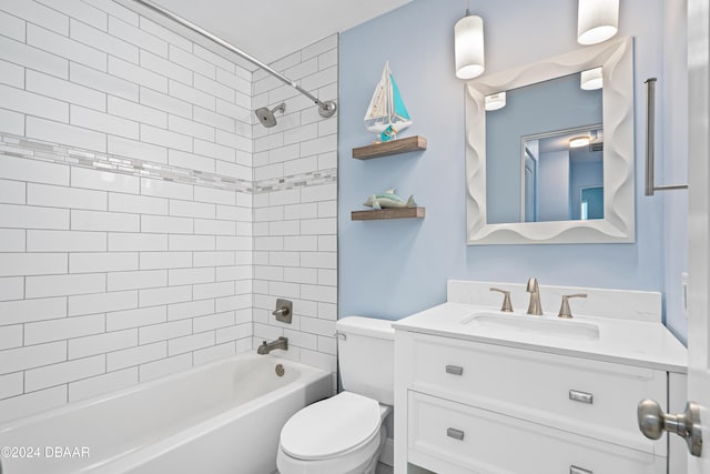 full bathroom with tiled shower / bath combo, toilet, and vanity