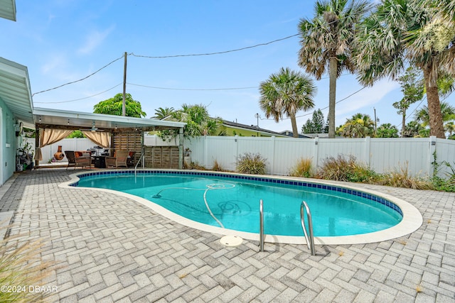 view of pool featuring a patio area and ceiling fan