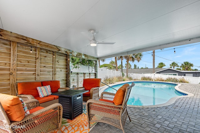 view of swimming pool featuring an outdoor living space, ceiling fan, and a patio