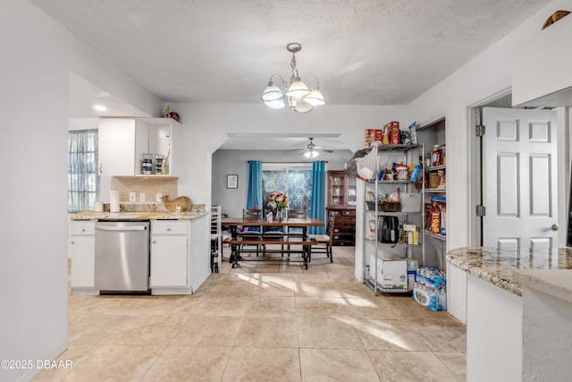 kitchen with a healthy amount of sunlight, white cabinets, dishwasher, and decorative backsplash