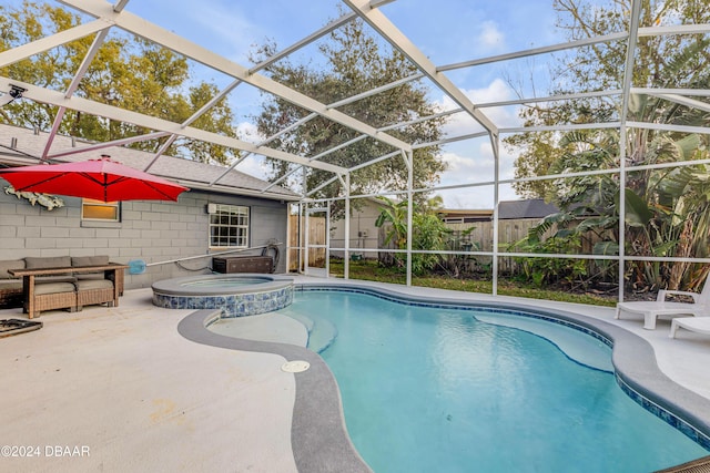 view of pool featuring a patio, glass enclosure, an outdoor hangout area, fence, and a pool with connected hot tub