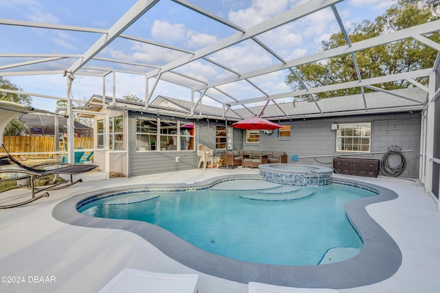 view of pool with a patio area, a lanai, a pool with connected hot tub, and fence