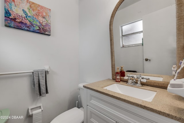 half bathroom featuring toilet and vanity