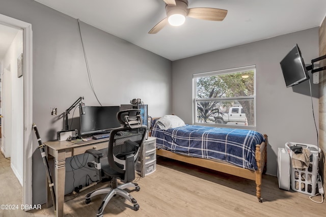 bedroom with light wood finished floors and a ceiling fan