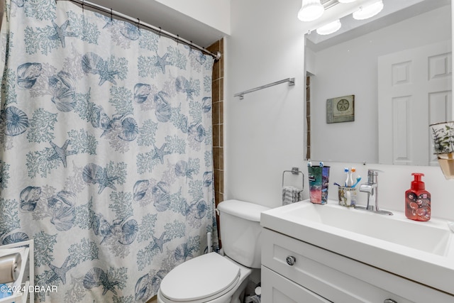 full bathroom featuring curtained shower, vanity, and toilet