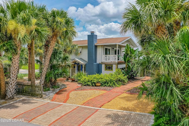 4026 Cardinal Blvd, Wilbur-By-The-Sea, FL 32127 - view of front of house with a balcony and a chimney