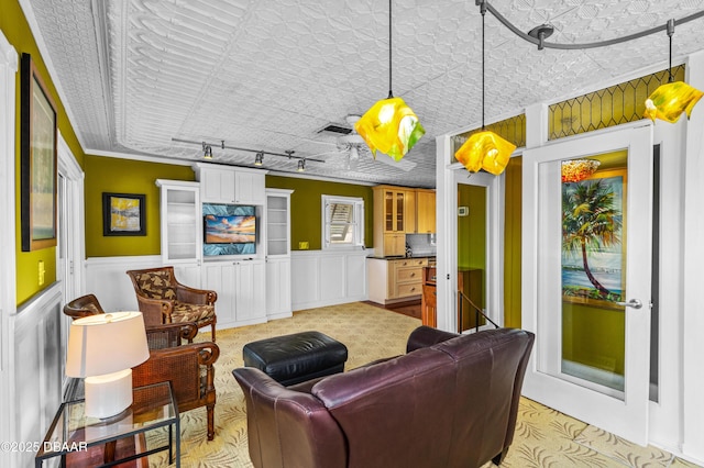 4026 Cardinal Blvd, Wilbur-By-The-Sea, FL 32127 - living area featuring an ornate ceiling, wainscoting, track lighting, crown molding, and light carpet