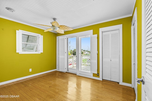 4026 Cardinal Blvd, Wilbur-By-The-Sea, FL 32127 - unfurnished bedroom featuring access to outside, crown molding, wood finished floors, and a ceiling fan