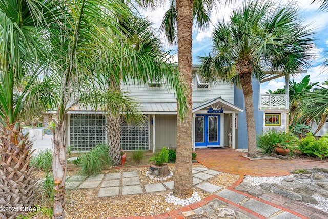 4026 Cardinal Blvd, Wilbur-By-The-Sea, FL 32127 - rear view of house with french doors and board and batten siding