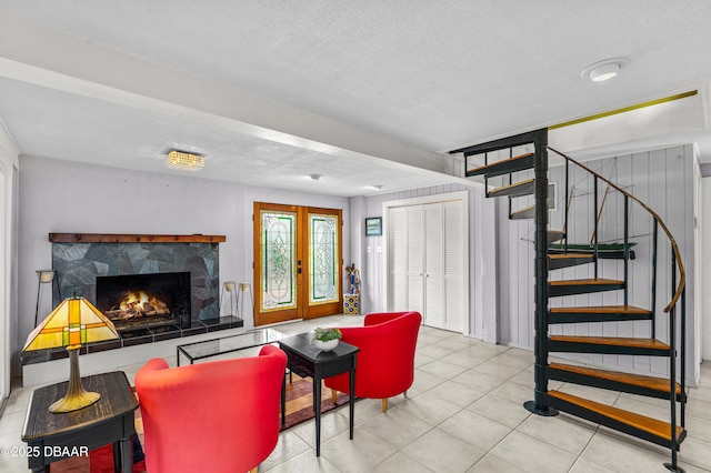 4026 Cardinal Blvd, Wilbur-By-The-Sea, FL 32127 - tiled living room featuring stairway, a fireplace, and a textured ceiling