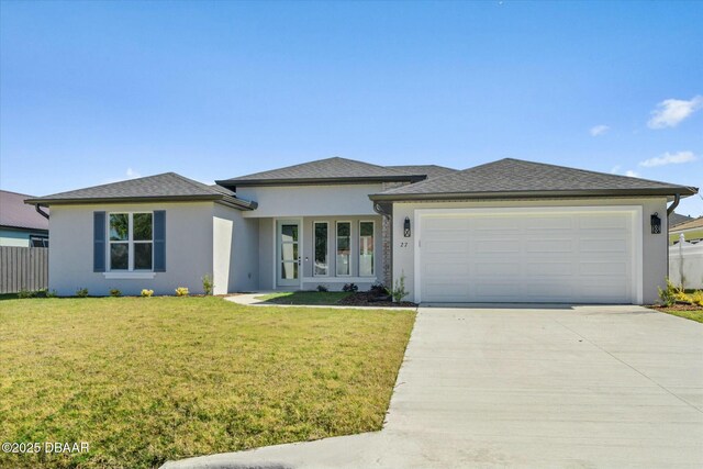 view of front facade with a garage and a front yard