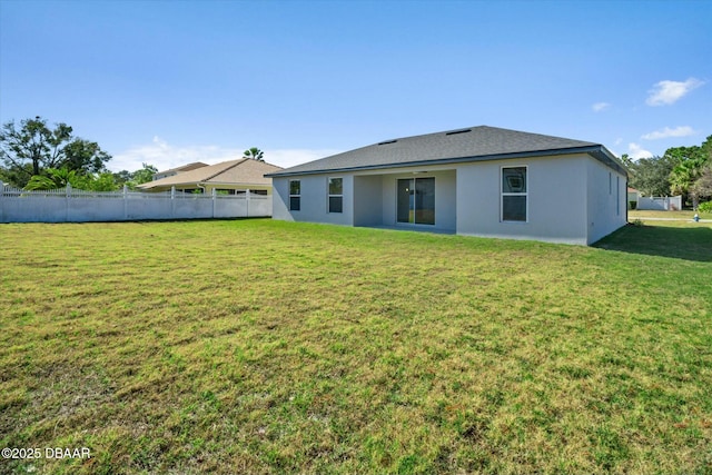 back of house with a yard