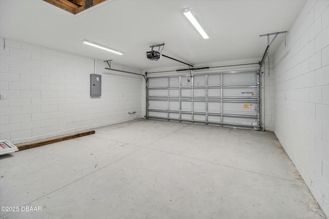 garage with a garage door opener and electric panel