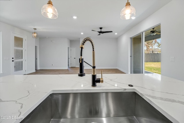 room details with light stone countertops and pendant lighting