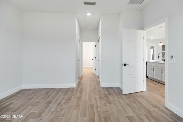 hallway with light hardwood / wood-style floors