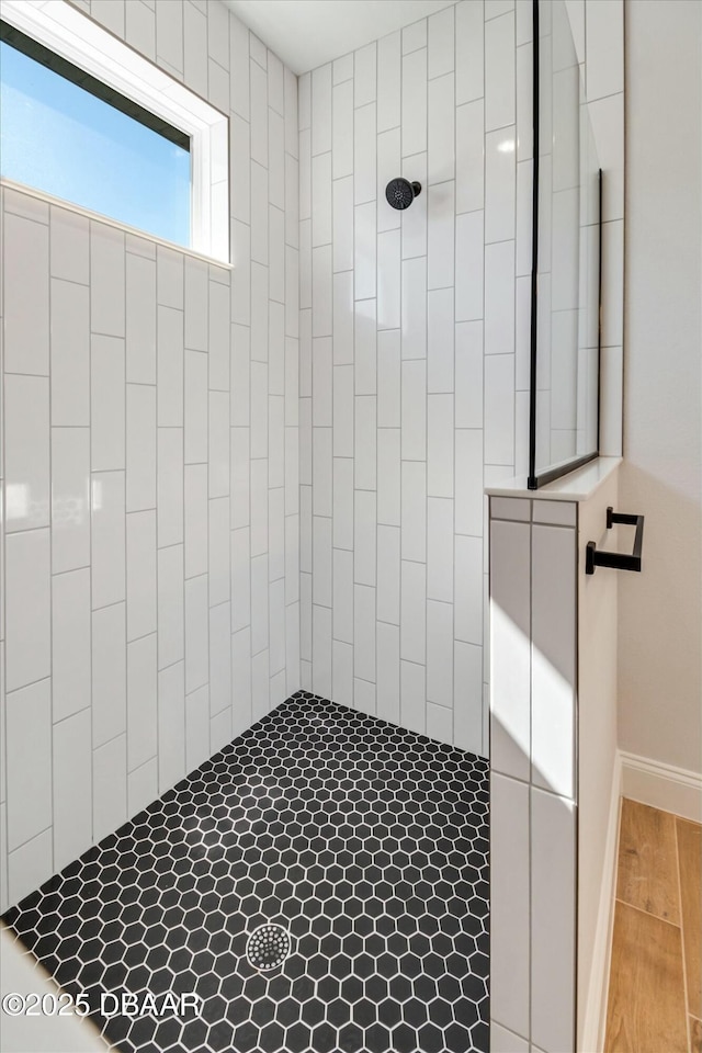 bathroom with tiled shower