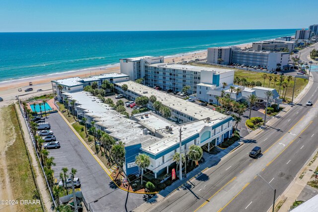 birds eye view of property with a water view and a view of the beach