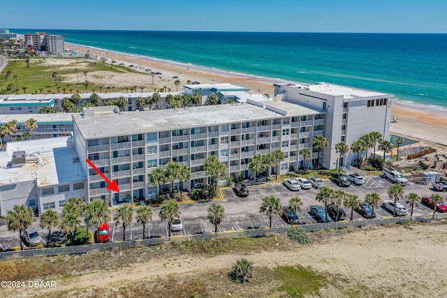 aerial view featuring a view of the beach and a water view