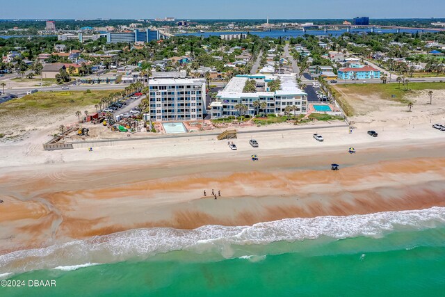 drone / aerial view with a beach view and a water view