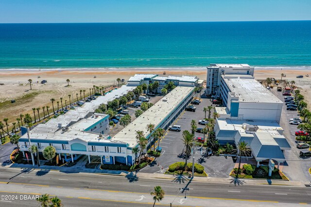 birds eye view of property with a view of the beach and a water view