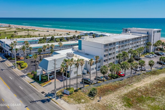 drone / aerial view featuring a beach view and a water view