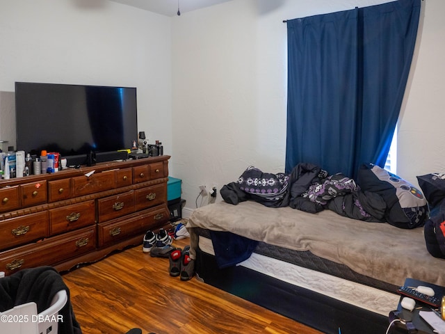 bedroom featuring wood finished floors