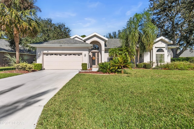 single story home featuring a front lawn and a garage