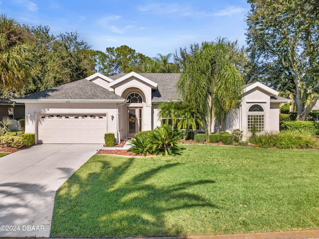 ranch-style house with a garage and a front yard