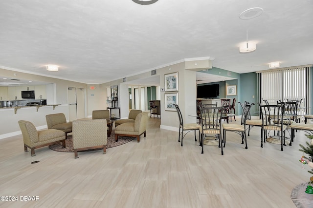 living room featuring light hardwood / wood-style floors and crown molding