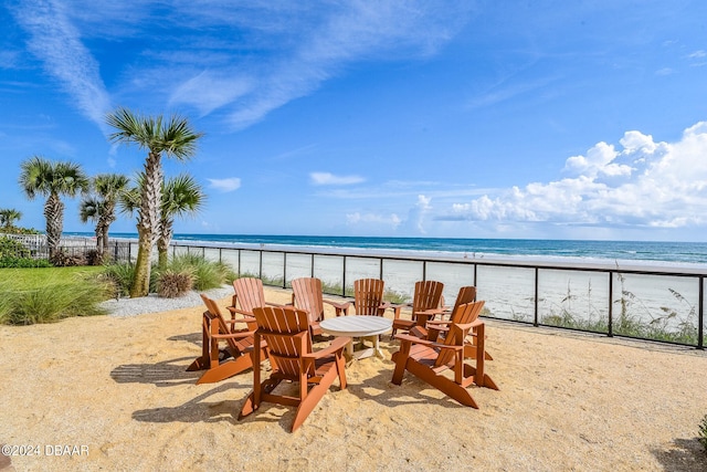 view of patio featuring a view of the beach and a water view