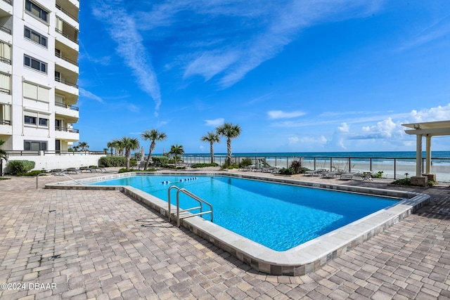 view of swimming pool featuring a water view