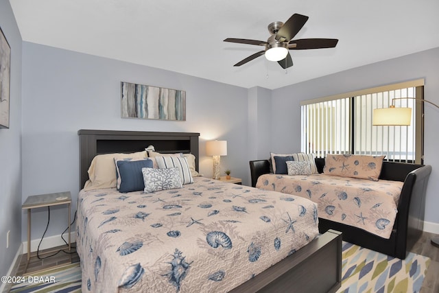 bedroom with hardwood / wood-style floors and ceiling fan