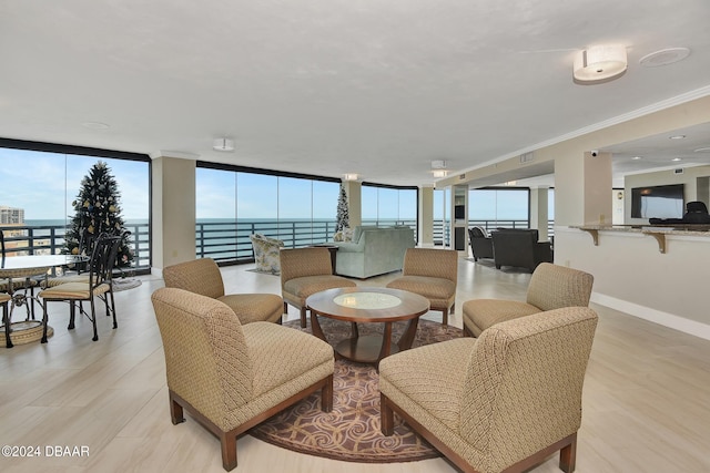 living room featuring expansive windows, a water view, and ornamental molding