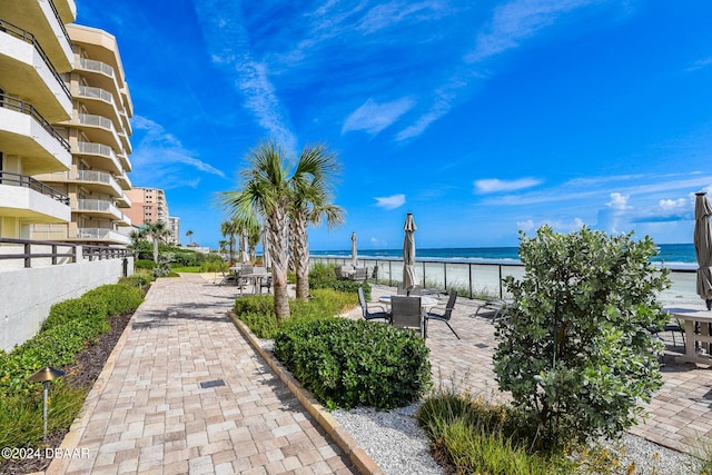 view of patio with a water view and a balcony