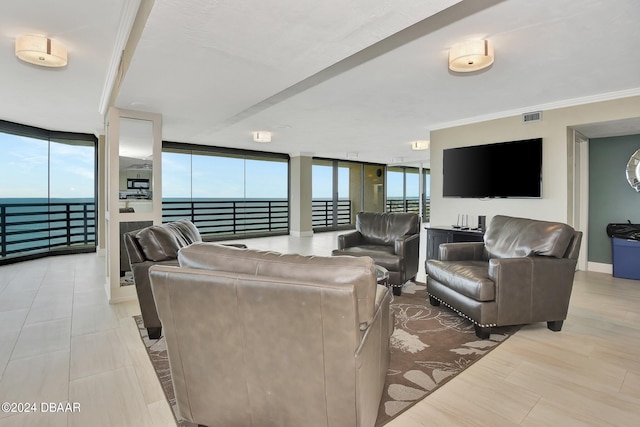 living room featuring crown molding, a water view, and floor to ceiling windows