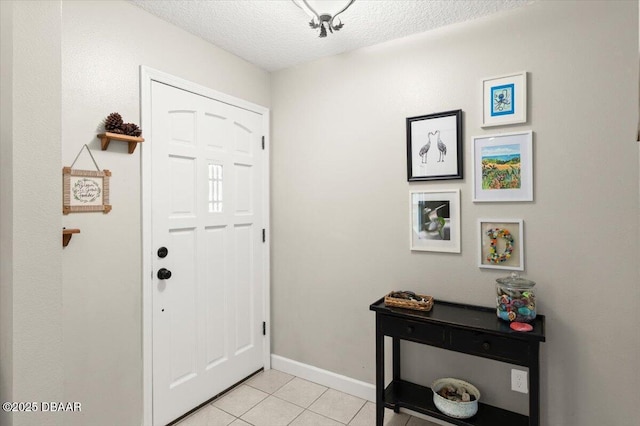2455 Whooping Crane Dr, Deleon Springs, FL 32130 - entrance foyer with light tile patterned floors and a textured ceiling